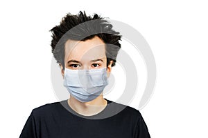 Unhappy, mad young man wearing a protective face mask prevent virus infection or pollution on white isolated background