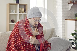 Unhappy man in cold season freezes in his house having problems with central heating.