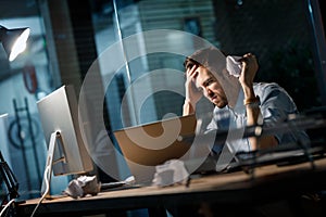 Unhappy man crumpling papers