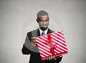 Unhappy man, displeased with new gift