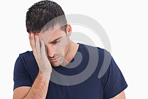 Unhappy man with head in hand