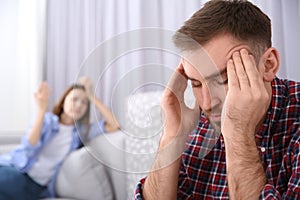 Unhappy man after quarrel with his girlfriend indoors. Relationship problems