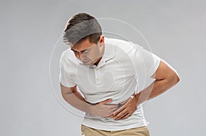 Unhappy man suffering from stomach ache