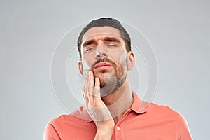 Unhappy man suffering from toothache