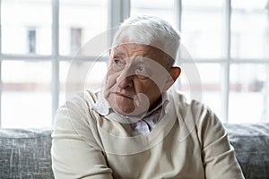 Unhappy mature senior man feeling loneliness indoors.