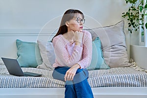 Unhappy mature woman experiencing headaches stress depression sitting on couch at home