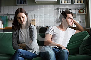 Unhappy millennial couple ignoring each other not talking after