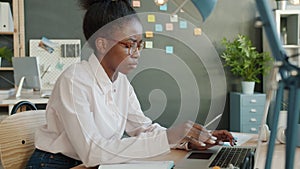 Unhappy mixed race girl working with laptop computer in office then feeling mad and leaving