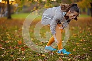 unhappy modern woman in fitness clothes in park