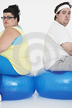 Unhappy Overweight Couple Sitting On Exercise Balls