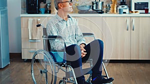 Unhappy paralysed senior man in wheelchair