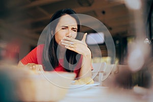 Woman Feeling Sick and Disgusted by Food Course in a Restaurant