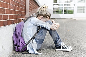 Unhappy Pre teen girl at school