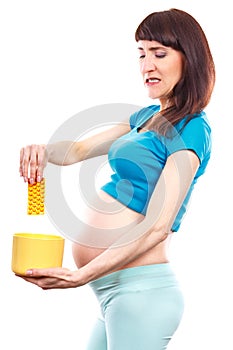 Unhappy pregnant woman throwing medical pills, reduction of using tablets in pregnancy