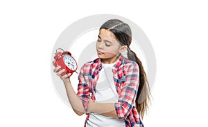 unhappy punctual teen girl with alarm in studio. punctual teen girl with alarm on background.