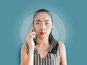 Unhappy and sad woman talking on smartphone.
