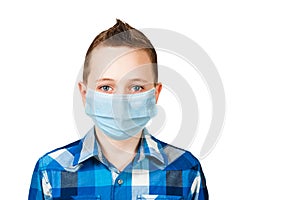 Unhappy, sad young boy wearing a protective face mask prevent virus infection or pollution on white isolated background