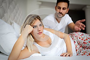 Unhappy young couple having unsolved relationship problems photo
