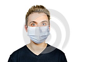 Unhappy, sad young guy wearing a protective face mask prevent virus infection or pollution on white isolated background