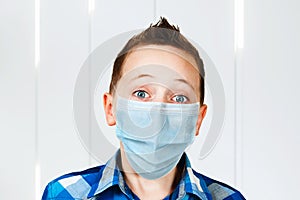 Unhappy, sad young man wearing a protective face mask prevent virus infection or pollution