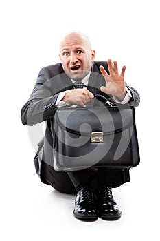 Unhappy scared or terrified businessman in depression hand holding briefcase