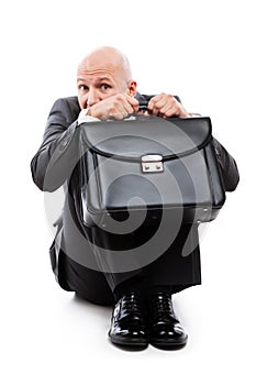 Unhappy scared or terrified businessman in depression hand holding briefcase