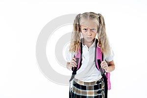 Unhappy school girl holding a big schoolbag full of books and homework isolated on white background in back to school learning