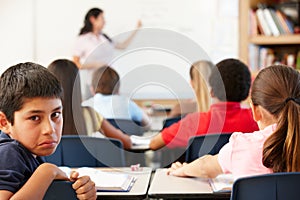 Unhappy schoolboy in class