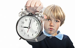 Unhappy schoolboy with clock