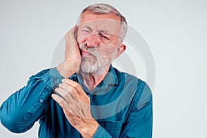 Unhappy senior man with closed eyes holding cheek isolated white background, strong pain in tooth decay