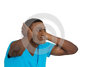 Unhappy stressed man covering his ears looking up