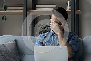 Unhappy stressed young man feeling confused of getting bad news.