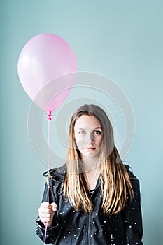 Unhappy teen with pink balloon