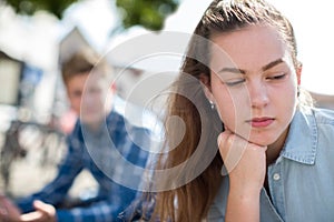 Unhappy Teenage Couple Having Argument In Urban Setting