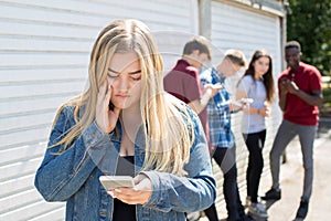 Unhappy Teenage Girl Being Bullied By Text Message