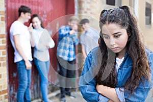 Unhappy Teenage Girl Being Gossiped About By Peers