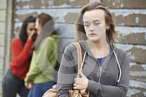 Unhappy Teenage Girl Being Gossiped About By Peers