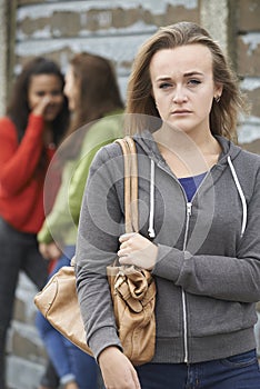 Unhappy Teenage Girl Being Gossiped About By Peers