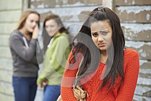 Unhappy Teenage Girl Being Gossiped About By Peers