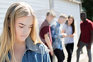 Unhappy Teenage Girl Being Gossiped About By Peers