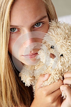 Unhappy teenage girl with cuddly toy