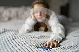 Unhappy Teenage Girl With Mobile Phone Lying On Bed At Home Anxious About Social Media Online Bullying And Using Phone Too Much