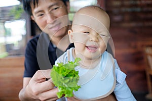 Unhappy toddler doesn`t want eat healthy vegetables photo