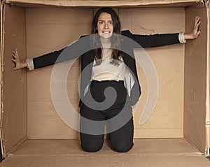 Unhappy unemployed business woman trying to increase her cramped office