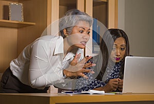 Upset business woman nagging and scolding on employee girl angry for computer mistake in office boss or chief authority and