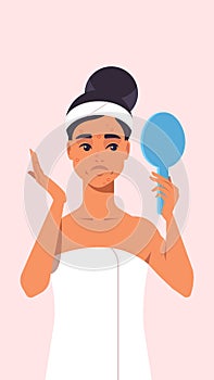 unhappy woman with acne problem looking in mirror dressed in towel girl facial treatment concept portrait