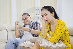 Unhappy woman being ignored by her husband