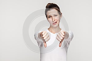 Unhappy woman demonstrate dislike sign photo