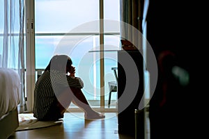Unhappy woman feeling lonely and sad, sitting on floor at home, thinking about problems, psychological and mental troubles, bad