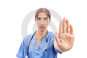 Unhappy woman female nurse making stop refusal gesture with palm